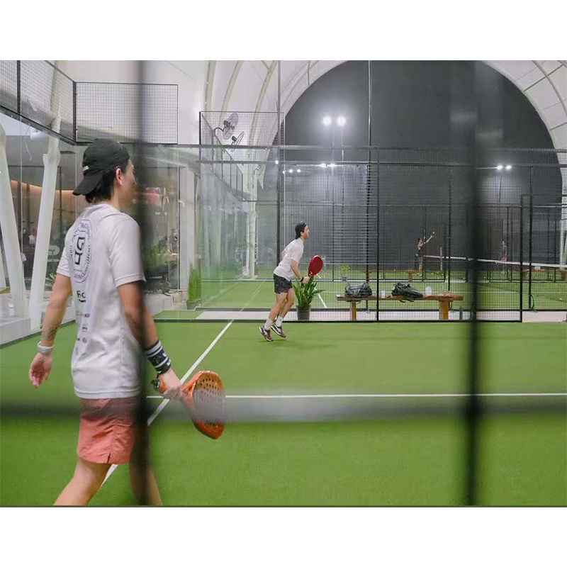 Indoor padel court beneath a white arched sport roof cover